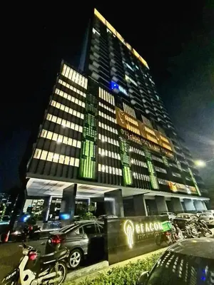 a tall building with a car parked in front of it at Rooftop - Sky Pool - 2BR Premium Homestay - Georgetown \u57ce\u5e02 6 pax in George Town