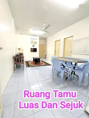 a living room with a table and chairs at Putra 2 Homestay in Gua Musang