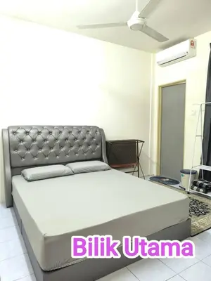 a bed in a room with a silver bed frame at Putra 2 Homestay in Gua Musang