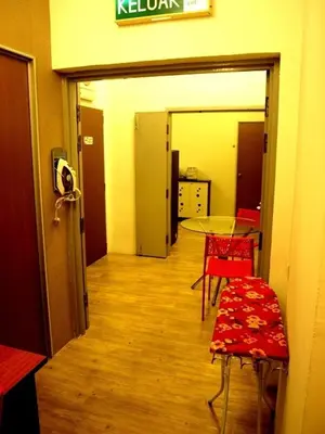 a hallway with a room with a table and chairs at Fang Zu Ming Concept Guesthouse in Ayer Itam