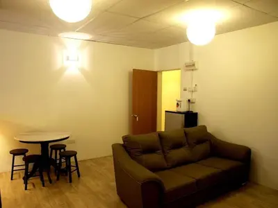 a living room with a couch and a table at Fang Zu Ming Concept Guesthouse in Ayer Itam