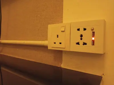 a light switch on the wall of a bathroom at Fang Zu Ming Concept Guesthouse in Ayer Itam