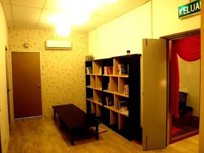 a room with a book shelf with books at Fang Zu Ming Concept Guesthouse in Ayer Itam