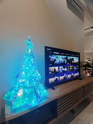 a christmas tree with blue lights on a television at ASC Smart Urban Suite Jelutong 2BR 3BR in Jelutong