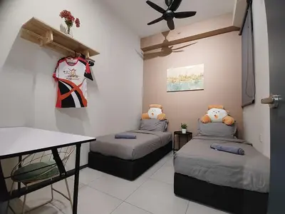 a room with two beds and a ceiling fan at ASC Smart Urban Suite Jelutong 2BR 3BR in Jelutong