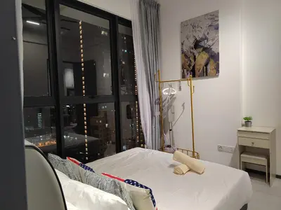 a bedroom with a bed and a large window at ASC Smart Urban Suite Jelutong 2BR 3BR in Jelutong
