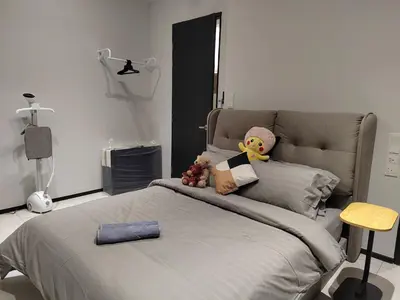 a bedroom with a bed with a teddy bear on it at ASC Smart Urban Suite Jelutong 2BR 3BR in Jelutong