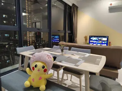 a teddy bear sitting next to a table in a restaurant at ASC Smart Urban Suite Jelutong 2BR 3BR in Jelutong