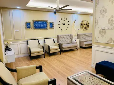 a waiting room with chairs and a clock on the wall at zam homestay kulim perdana hitech utk Msliim shj in Kulim