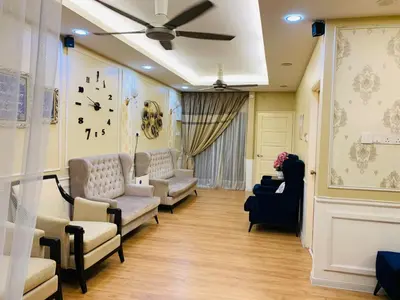 a living room with couches and a clock on the wall at zam homestay kulim perdana hitech utk Msliim shj in Kulim