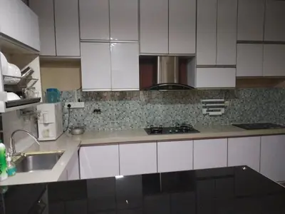 a kitchen with white cabinets and a sink at zam homestay kulim perdana hitech utk Msliim shj in Kulim