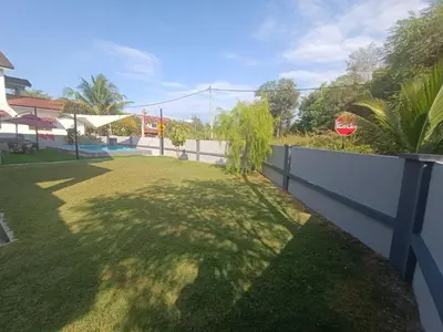 a yard with a fence and a stop sign at AYRA HOMESTAY in Kuala Kangsar