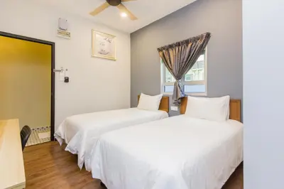 two beds in a room with a window at Newly 5BR Cottage House Retreats (Free Parking) in Butterworth