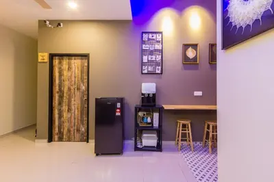 a room with a refrigerator and a counter with a table at Newly 5BR Cottage House Retreats (Free Parking) in Butterworth