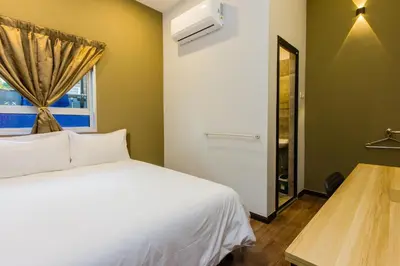 a bedroom with a white bed and a window at Newly 5BR Cottage House Retreats (Free Parking) in Butterworth