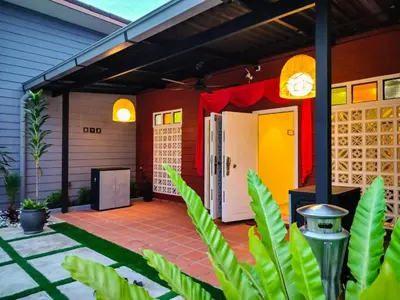 a porch of a house with a yellow and red at Newly 4BR Cottage House Retreats with Free Parking in Butterworth