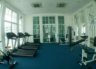 a gym with a row of treadms and cardio machines at The Trails Kampar in Kampong Malim Nawar