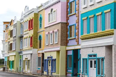 a row of houses with colorful doors and windows at The Trails Kampar in Kampong Malim Nawar