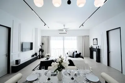 a white living room with a table and a couch at Batu Ferringhi By The Sea Luxurious 2BR Suite 6 Pax in Batu Ferringhi