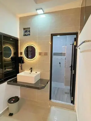a bathroom with a white sink and a shower at 82,Dream Guest House in Tanjung Piandang