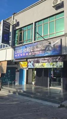 a building with a sign on the side of it at 82,Dream Guest House in Tanjung Piandang