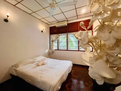 a bedroom with a bed and a window at Nature Surrounded Riverside Villa with BBQ ,& SWIMMING POOL in George Town