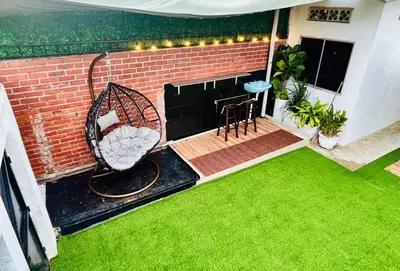 a small backyard with a lawn and a tennis racket at Nature Surrounded Riverside Villa with BBQ ,& SWIMMING POOL in George Town