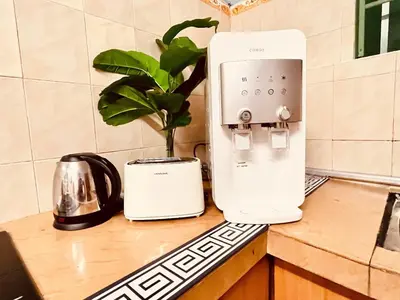 a toaster sitting on a counter next to a coffee maker at Nature Surrounded Riverside Villa with BBQ ,& SWIMMING POOL in George Town