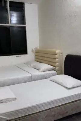 two beds sitting in a room with a window at GG 98 Hotel in George Town
