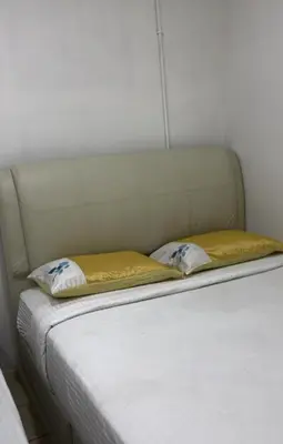 a white bed with two pillows on top of it at GG 98 Hotel in George Town