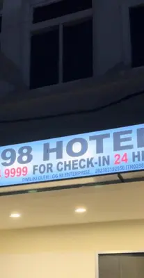 a sign that is on top of a building at GG 98 Hotel in George Town