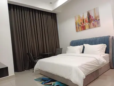 a bedroom with a bed and a large window at RJ Studio 1 - Kompleks Mutiara in Gua Musang