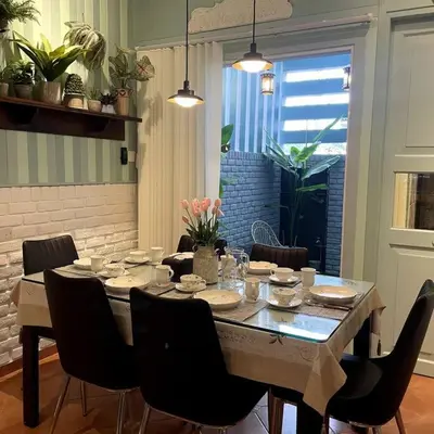 a dining room table with chairs and a large window at YouLuvHomestay 4BR for 16-18 Pax Gunung Rapat Ipoh in Ipoh