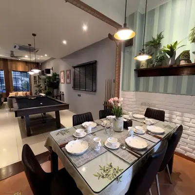 a dining room with a table with chairs and a pool table at YouLuvHomestay 4BR for 16-18 Pax Gunung Rapat Ipoh in Ipoh