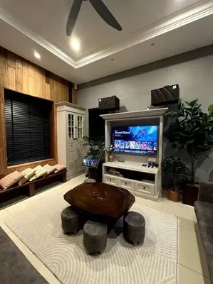 a living room with a table and a tv at YouLuvHomestay 4BR for 16-18 Pax Gunung Rapat Ipoh in Ipoh