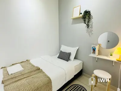 a small bedroom with a bed and a mirror at Ipoh Horizon Skypool Town Suites 4-11pax by IWH Suites in Ipoh