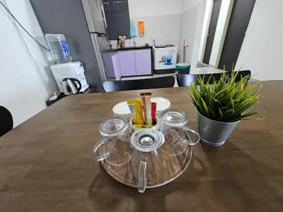 a table with glasses on top of a table at Seberang Jaya Family Pool Homestay Near Hospital 3 Bedroom Aircond 2 Bathroom & Family Room Aircond in Permatang Janggus