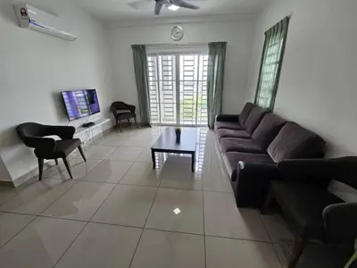 a living room with a couch and a table at Seberang Jaya Family Pool Homestay Near Hospital 3 Bedroom Aircond 2 Bathroom & Family Room Aircond in Permatang Janggus
