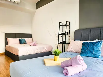 two beds in a room with pink towels on them at Tropicana 218 Macalister by NGN in George Town
