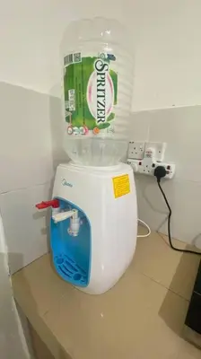 a drink container on top of a toilet in a bathroom at R&R Manjung Guest House at Pangsapuri Samudera in Seri Manjung