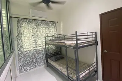 a room with two bunk beds and a window at R&R Manjung Guest House at Pangsapuri Samudera in Seri Manjung