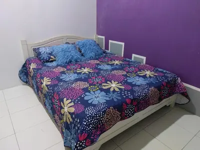 a bed with two stuffed animals laying on it at Puteri Homestay Sg Petani in Sungai Petani