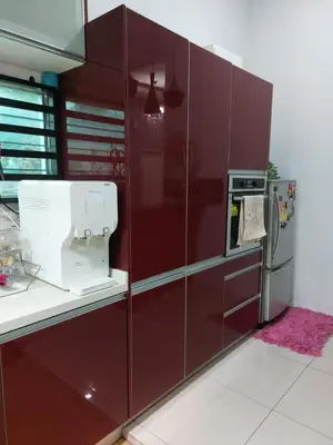 a red kitchen with a mixer and a refrigerator at Puteri Homestay Sg Petani in Sungai Petani