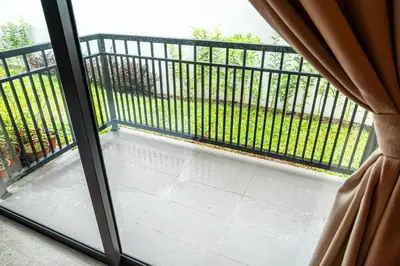 a view of a balcony with a fence from a window at The Farmhouse in Ipoh