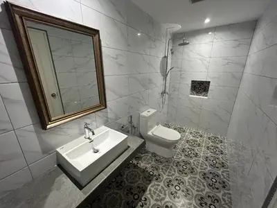 a bathroom with a sink and a toilet and a mirror at The Farmhouse in Ipoh