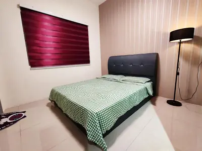 a bed in a room with a red painting on the wall at Pavilionvillie M1T696 by irainbow in Ipoh