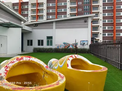 two large objects in a yard with a building at Pavilionvillie M1T696 by irainbow in Ipoh