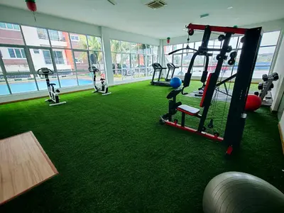a gym with several tread machines on a green floor at Pavilionvillie M1T686 by irainbow in Ipoh