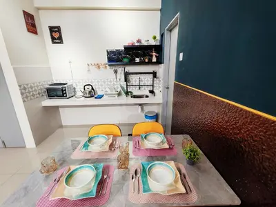 a table with two chairs and plates on it in a kitchen at Pavilionvillie M1T686 by irainbow in Ipoh