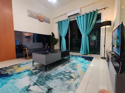 a living room with blue curtains and a tv at Pavilionvillie M1T686 by irainbow in Ipoh